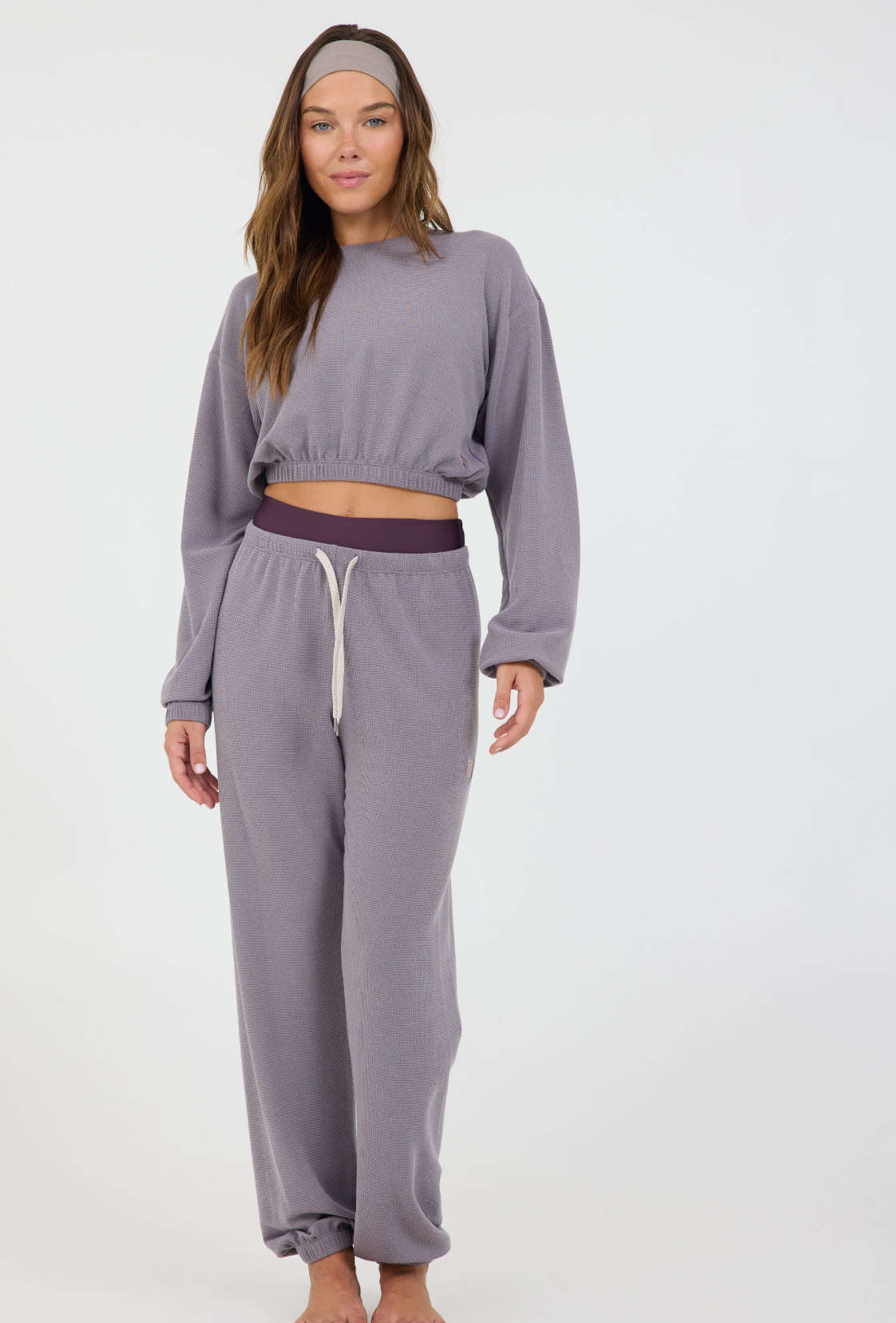 Caroline elasticized waist crop top with long sleeves and thumbholes in dark haze, modeled with the Delaney joggers from the front 