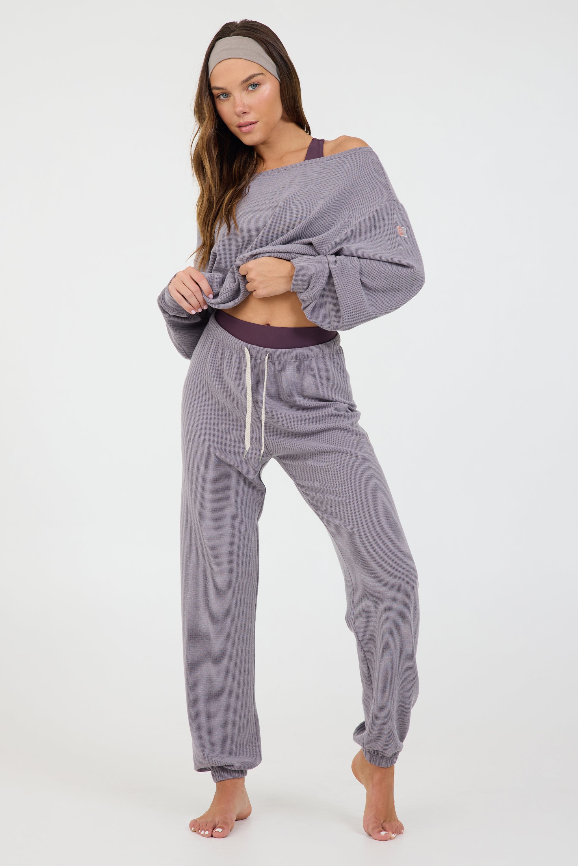 Delaney joggers in dark haze, modeled with the Amiee off the shoulder long sleeve from the front