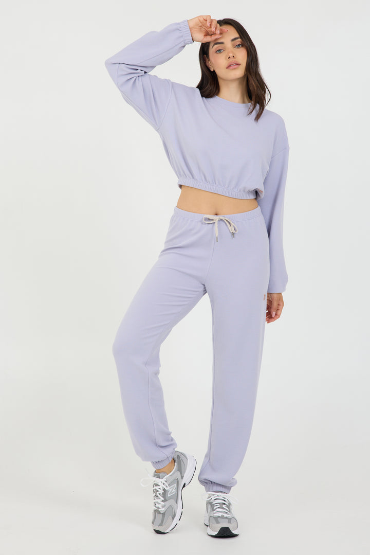 Delaney joggers in light amethyst, modeled with the Caroline elasticized waist crop top long sleeve from the front