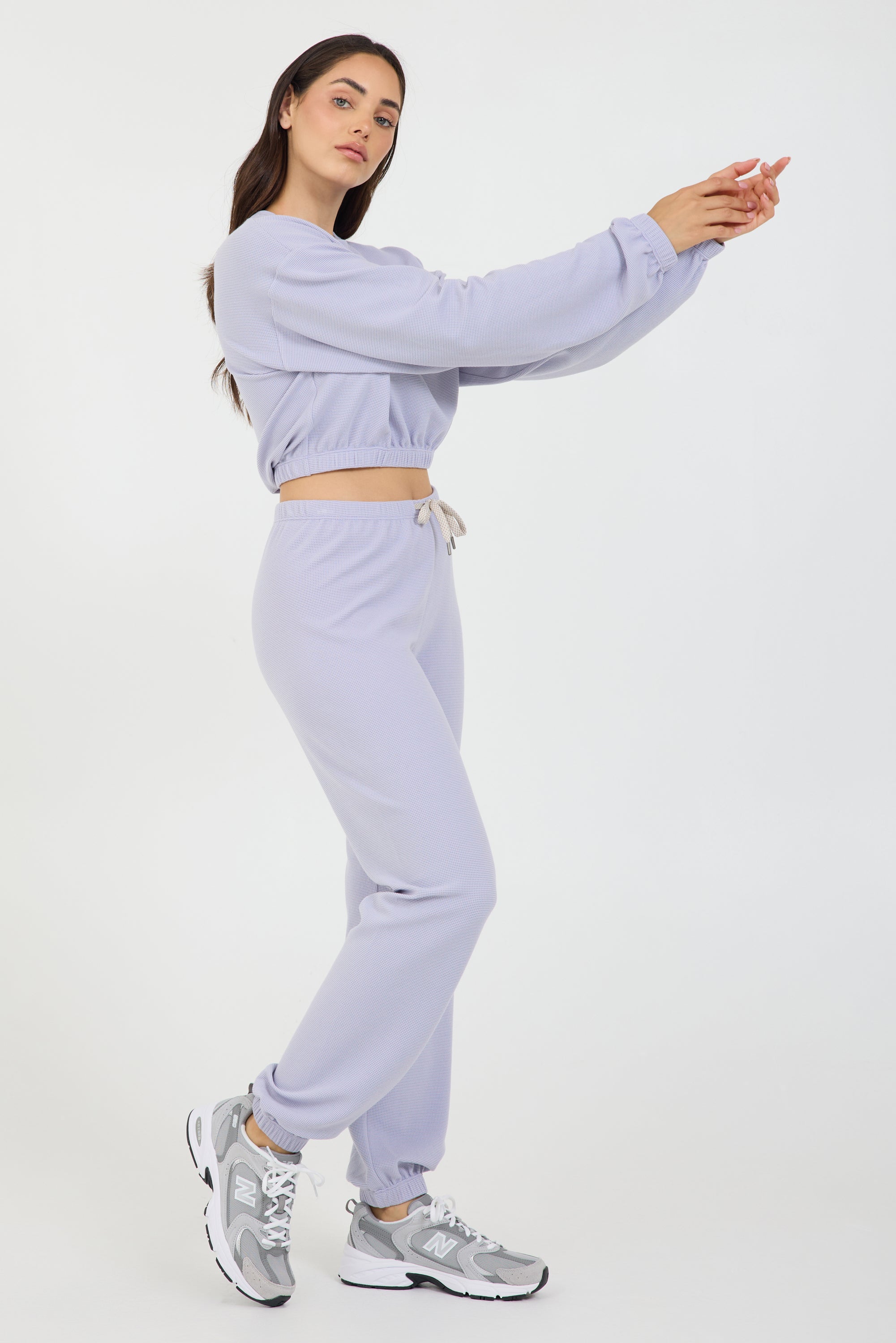 Delaney joggers in light amethyst, modeled with the Caroline elasticized waist crop top long sleeve from the side