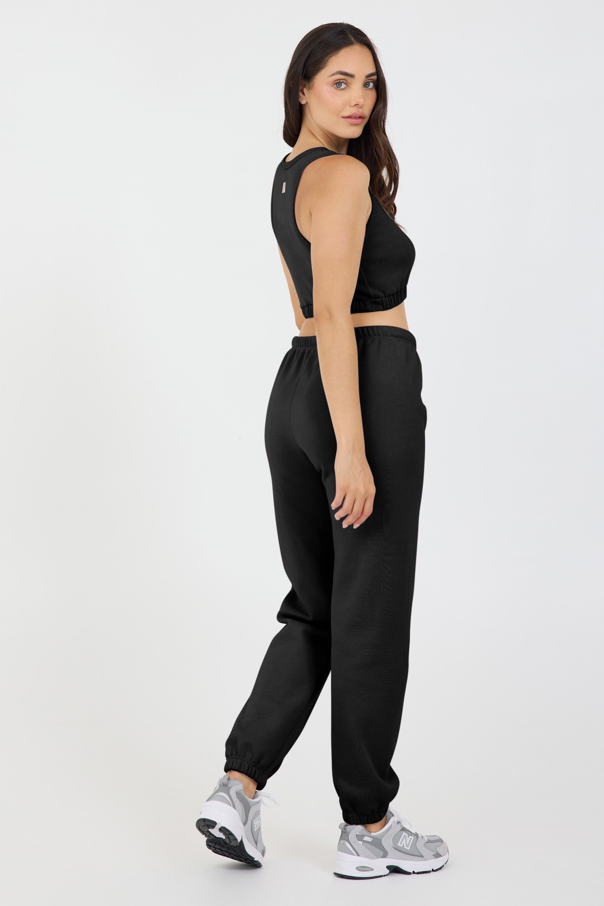 the Fleece elasticized waist tank top in black, modeled with the Lori Fleece joggers from the side