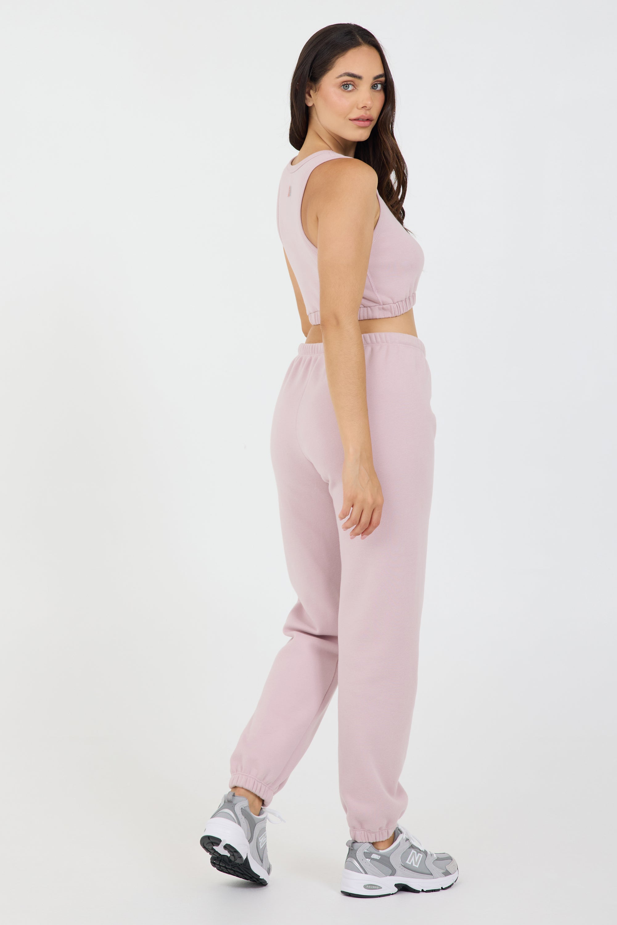 the Fleece elasticized waist tank top in dusty pink, modeled with the Lori Fleece joggers from the side