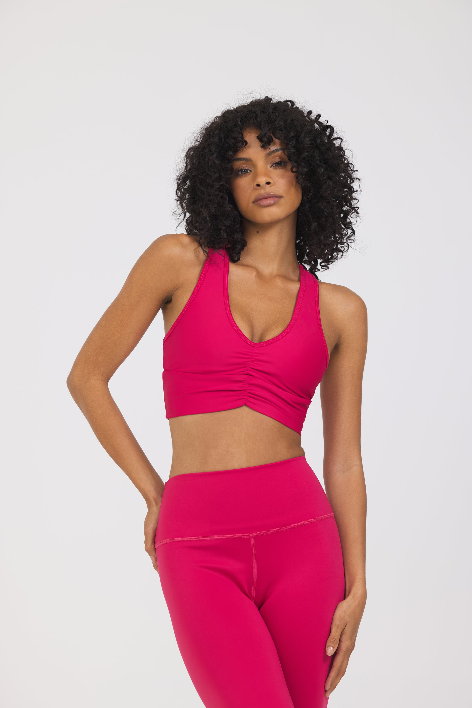 Julia Ruched front strapped bra in viva-mententa, modeled with the Kenzie 7/8 leggings from the front