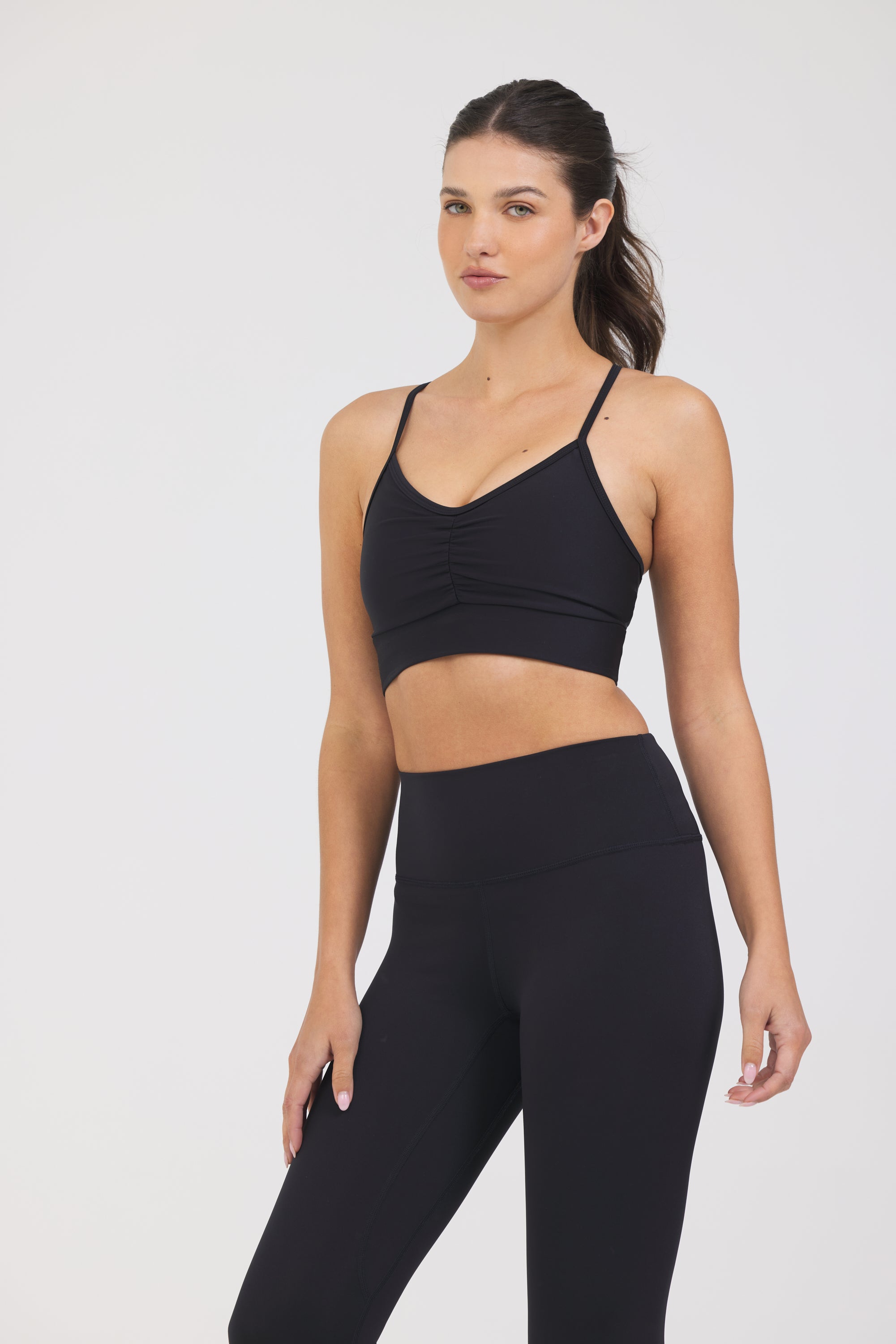 Karlee Ruched front strapped bra in black, modeled with the Kenzie  7/8 leggings from the front