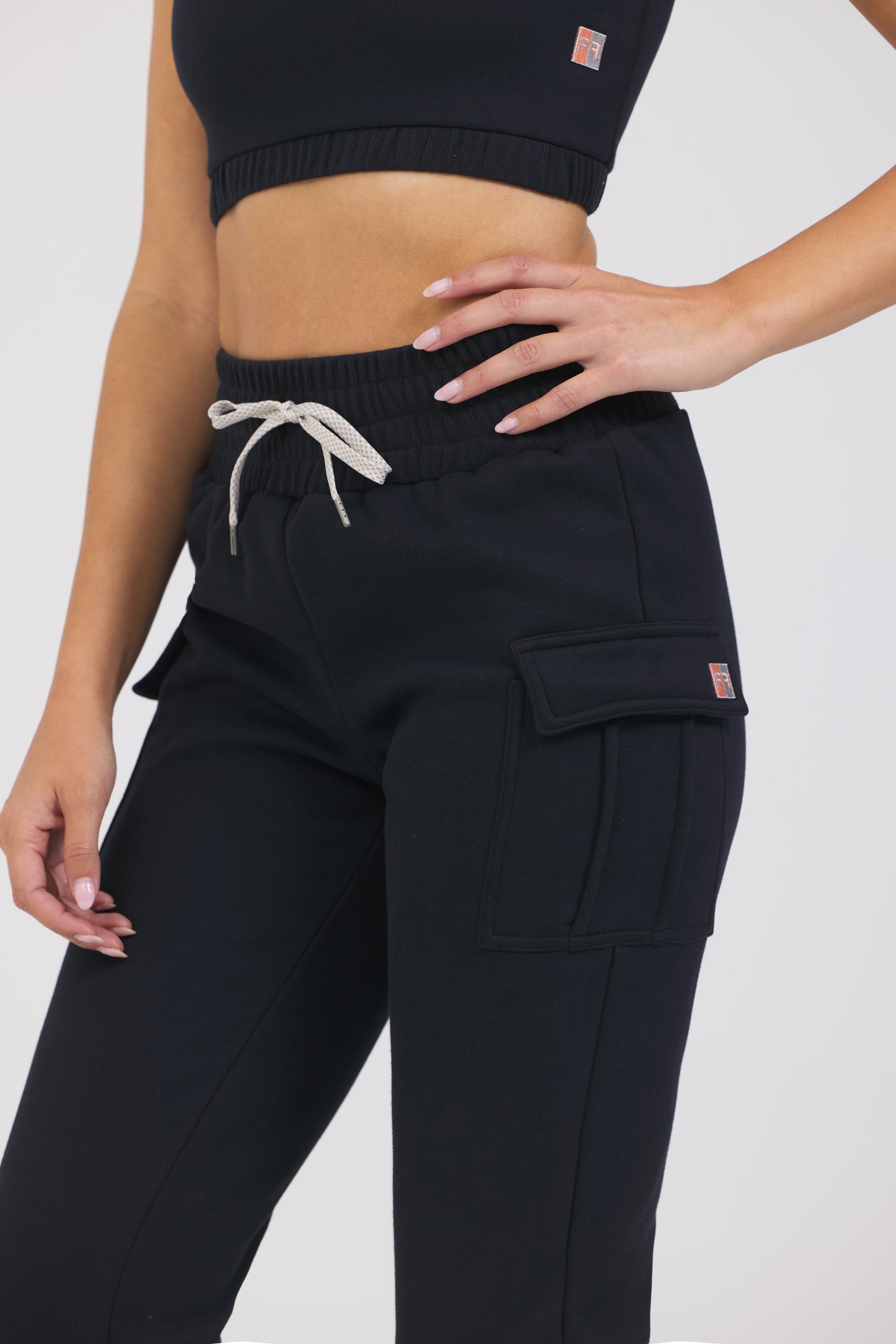 Kim Fleece cargo jogger in black, modeled with the elasticized waist tank close up