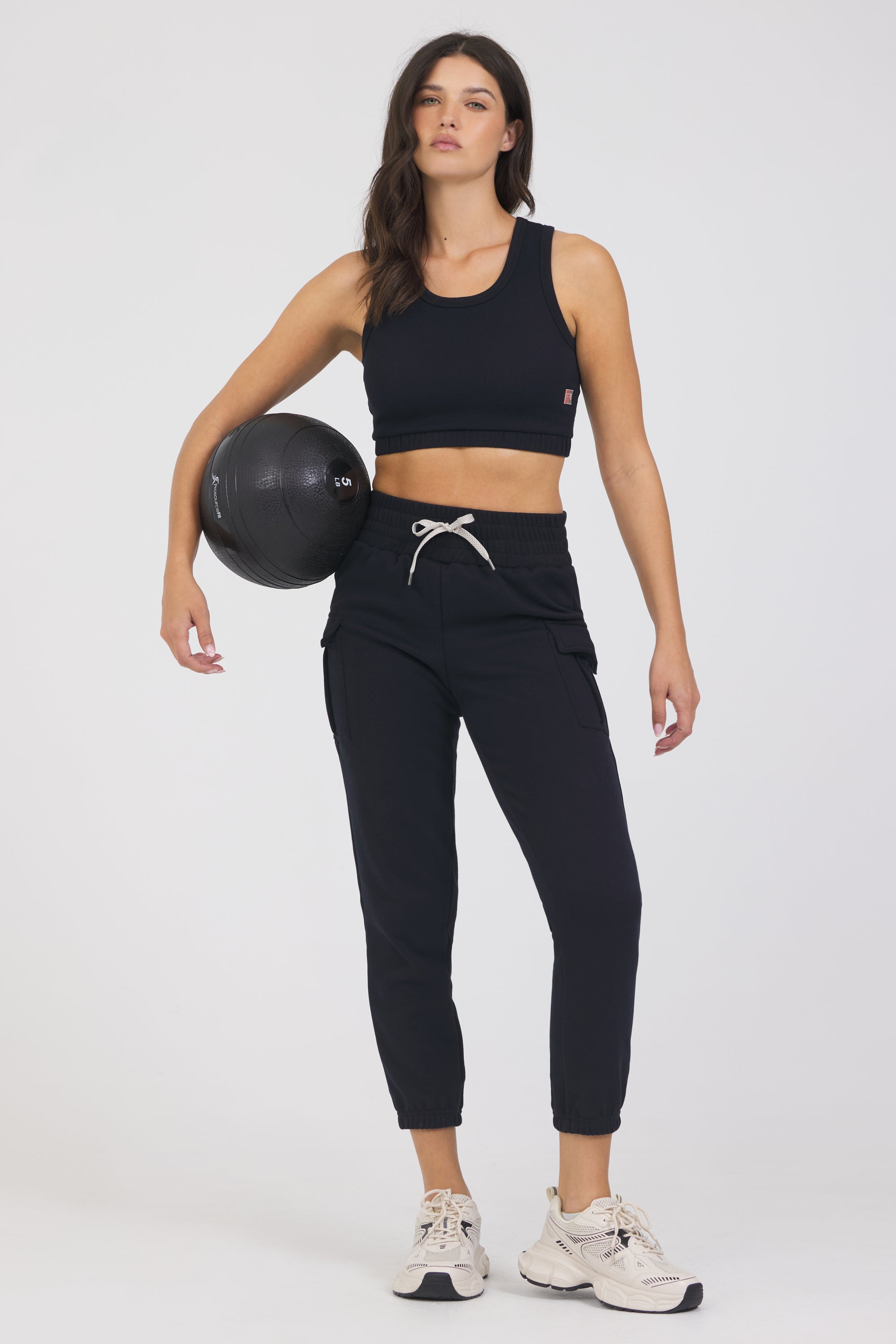 Kim Fleece cargo jogger in black, modeled with the elasticized waist tank from the front