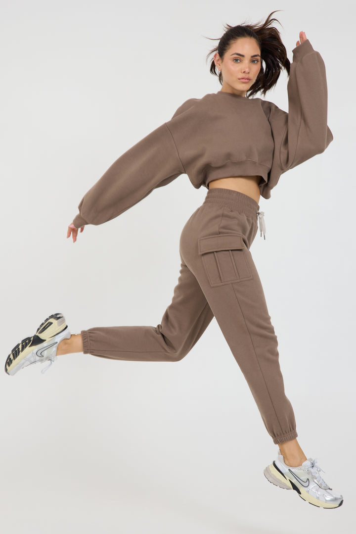 Kim Fleece cargo jogger in dark truffle, modeled with the Claire Fleece chopped long sleeve running side view