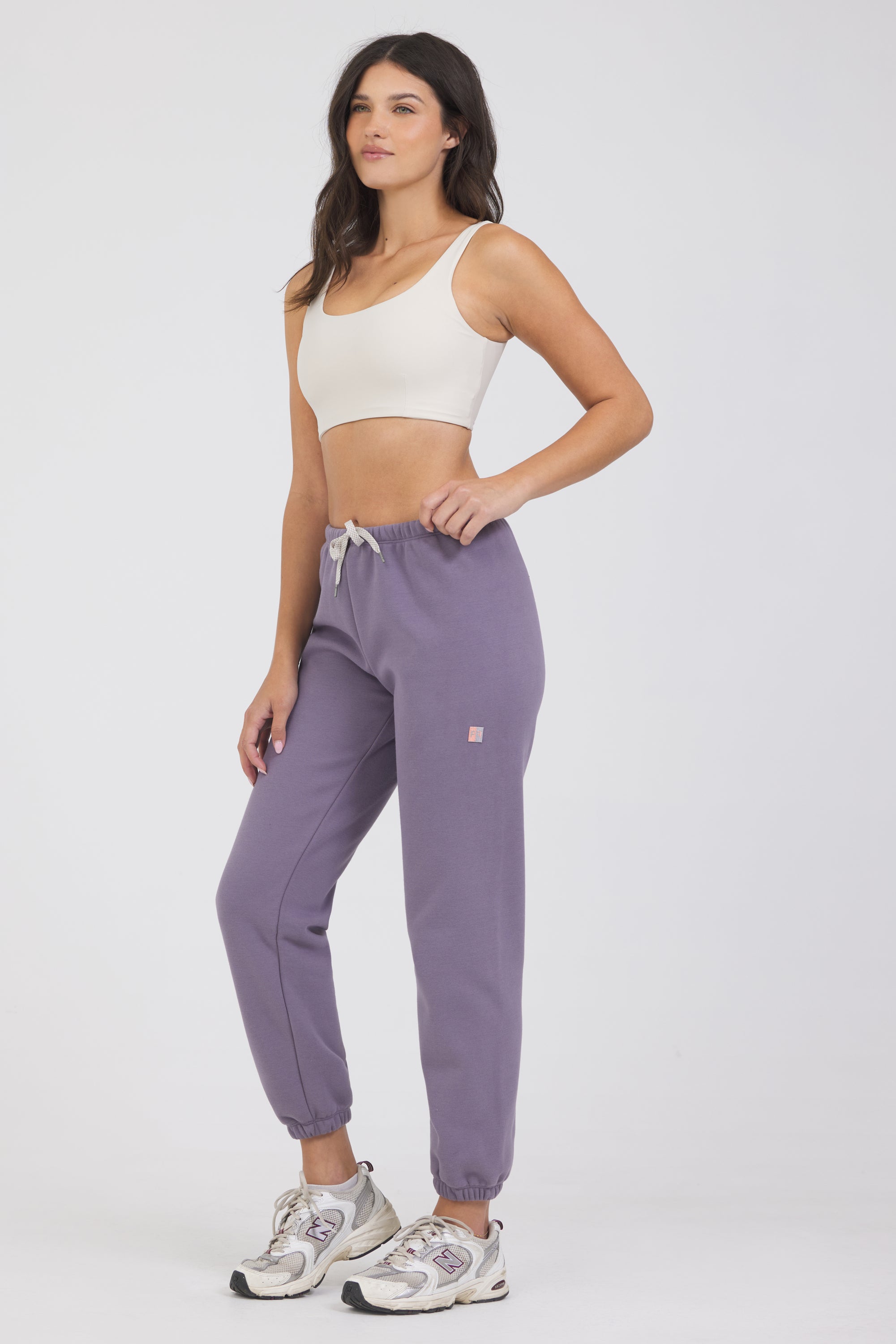 The Lori Fleece joggers in dark haze, modeled with the Fleece elasticized waist tank top from the front