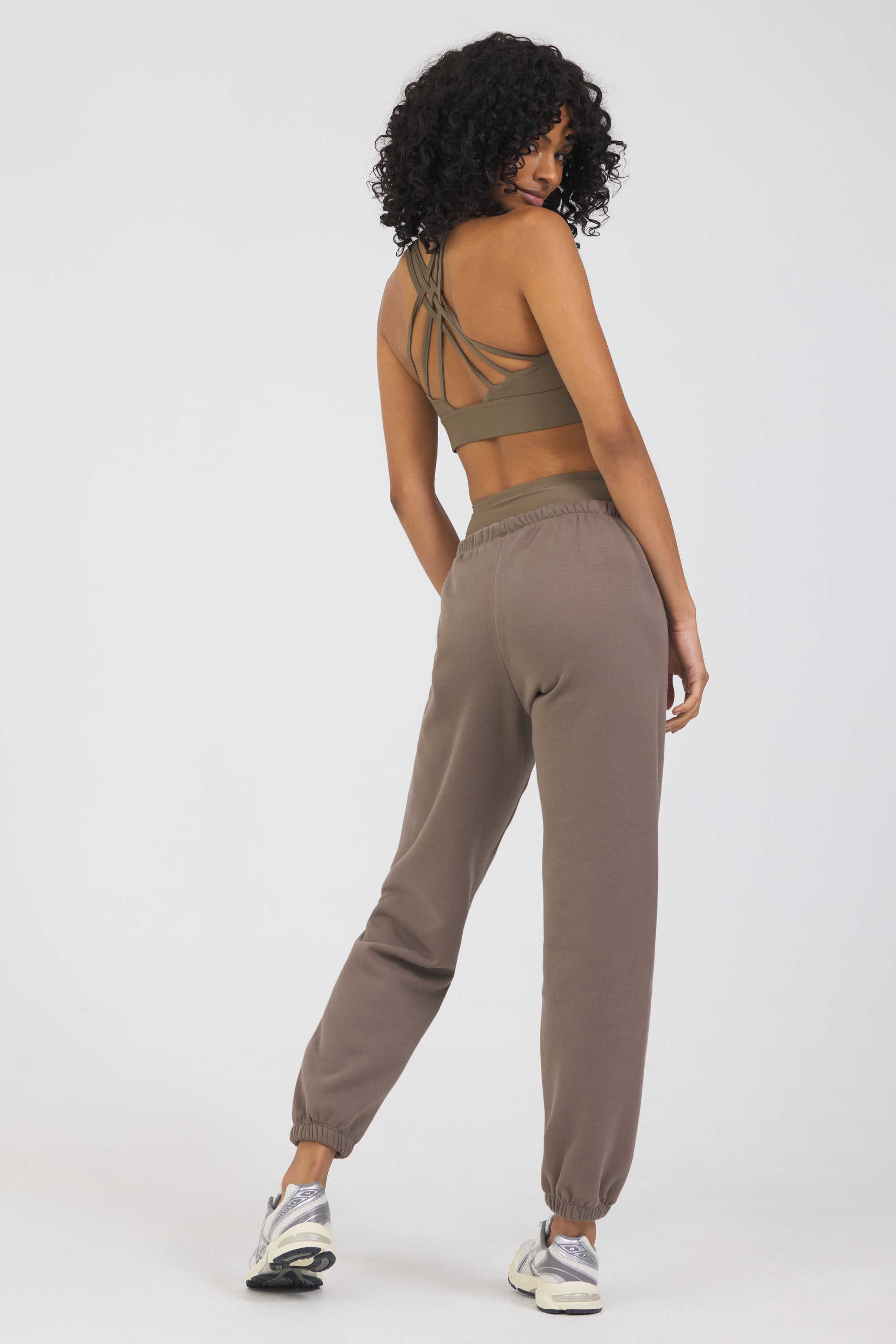 The Lori Fleece joggers in dark truffle, modeled with the Fleece elasticized waist tank top from the back
