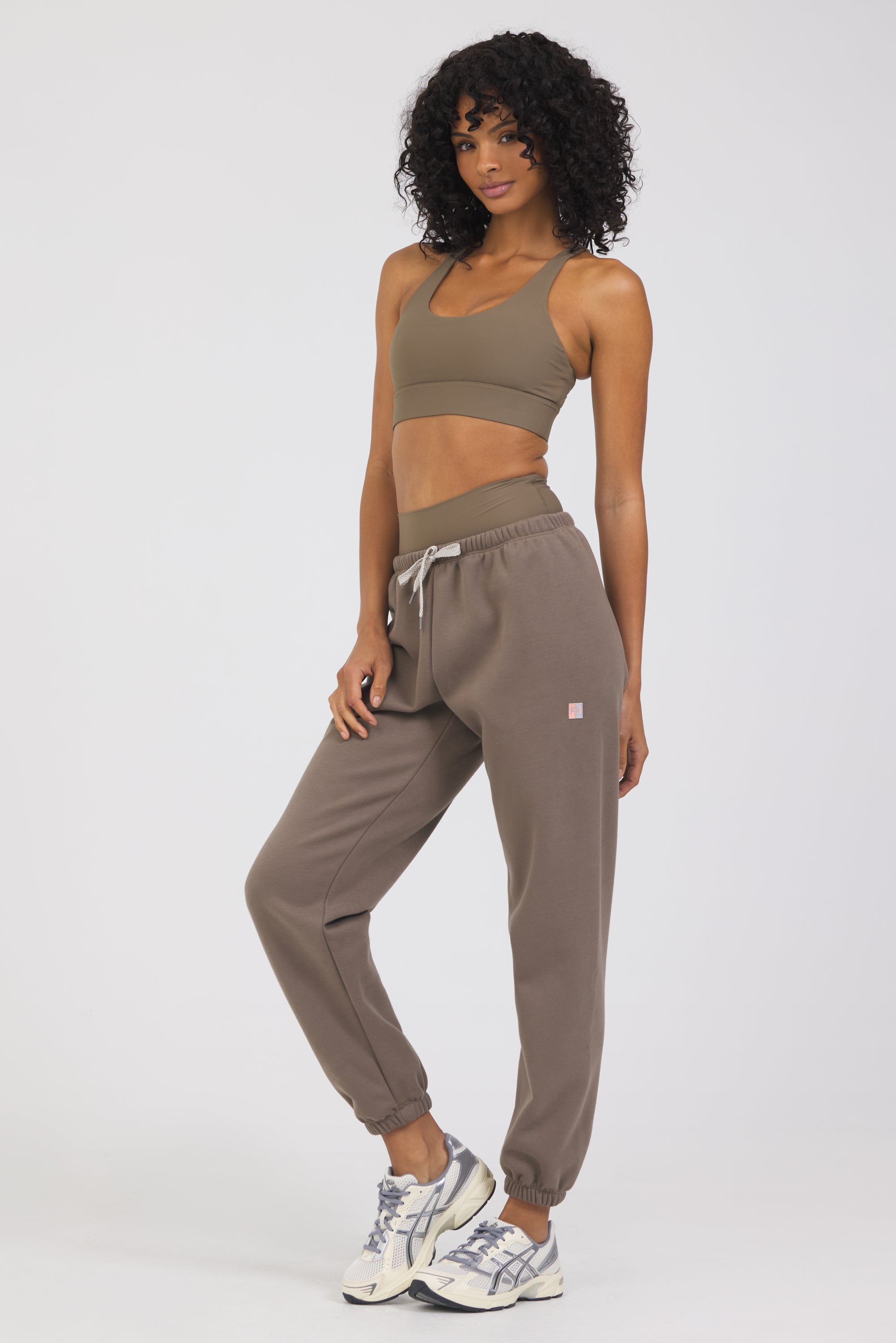 The Lori Fleece joggers in dark truffle, modeled with the Fleece elasticized waist tank top from the front