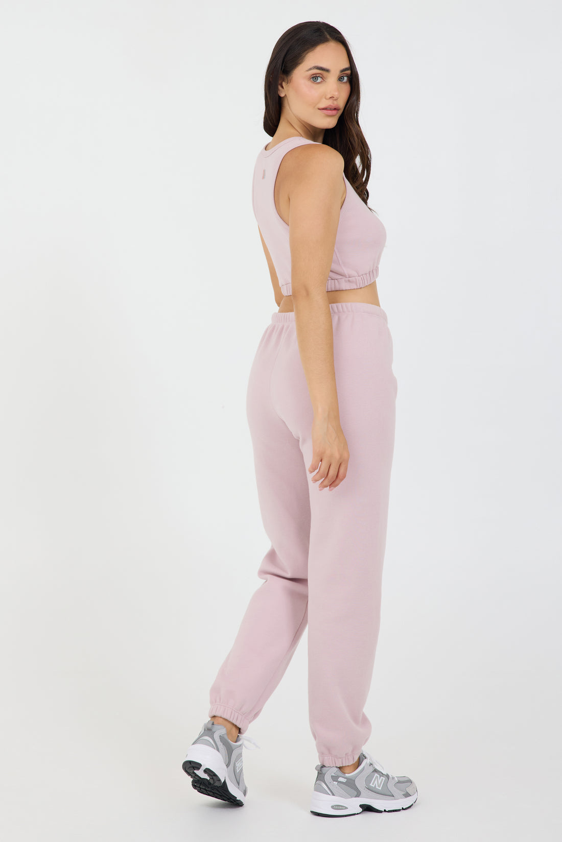 The Lori Fleece joggers in dusty pink, modeled with the Fleece elasticized waist tank top from the back