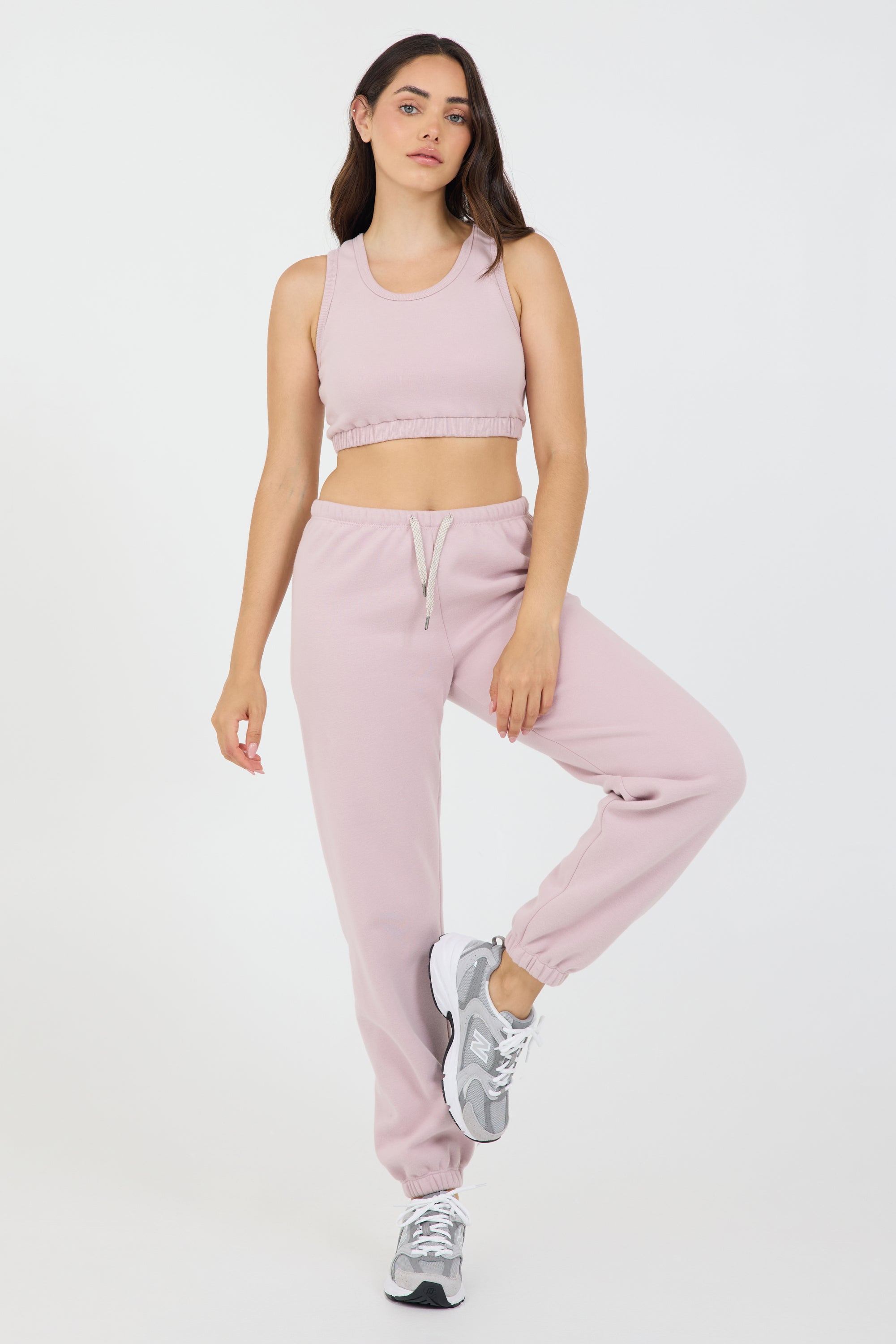 The Lori Fleece joggers in dusty pink, modeled with the Fleece elasticized waist tank top from the front