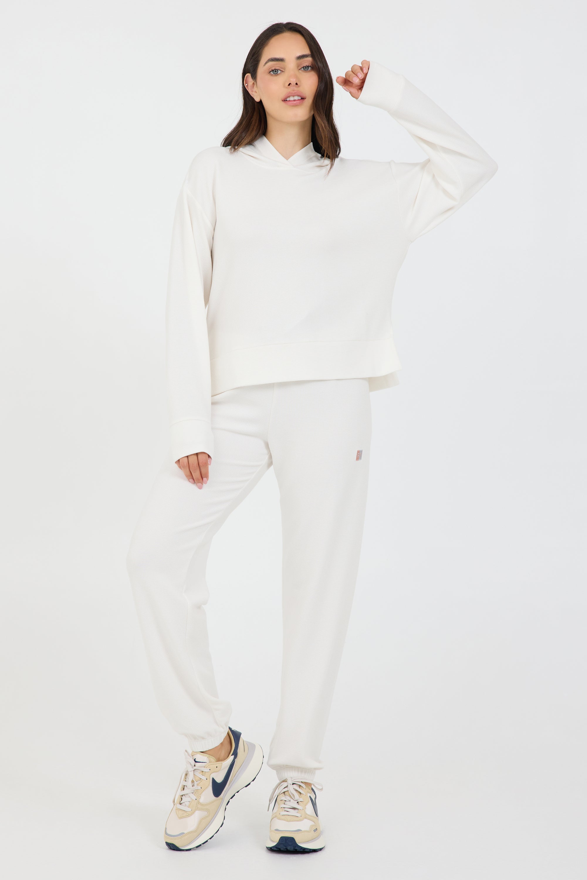Lynn pullover hoodie with long sleeves in coconut cream, modeled with the Delaney joggers from the front