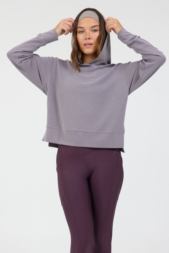 Lynn pullover hoodie with long sleeves in dark haze, modeled with the Robbie 7/8 leggings from the front