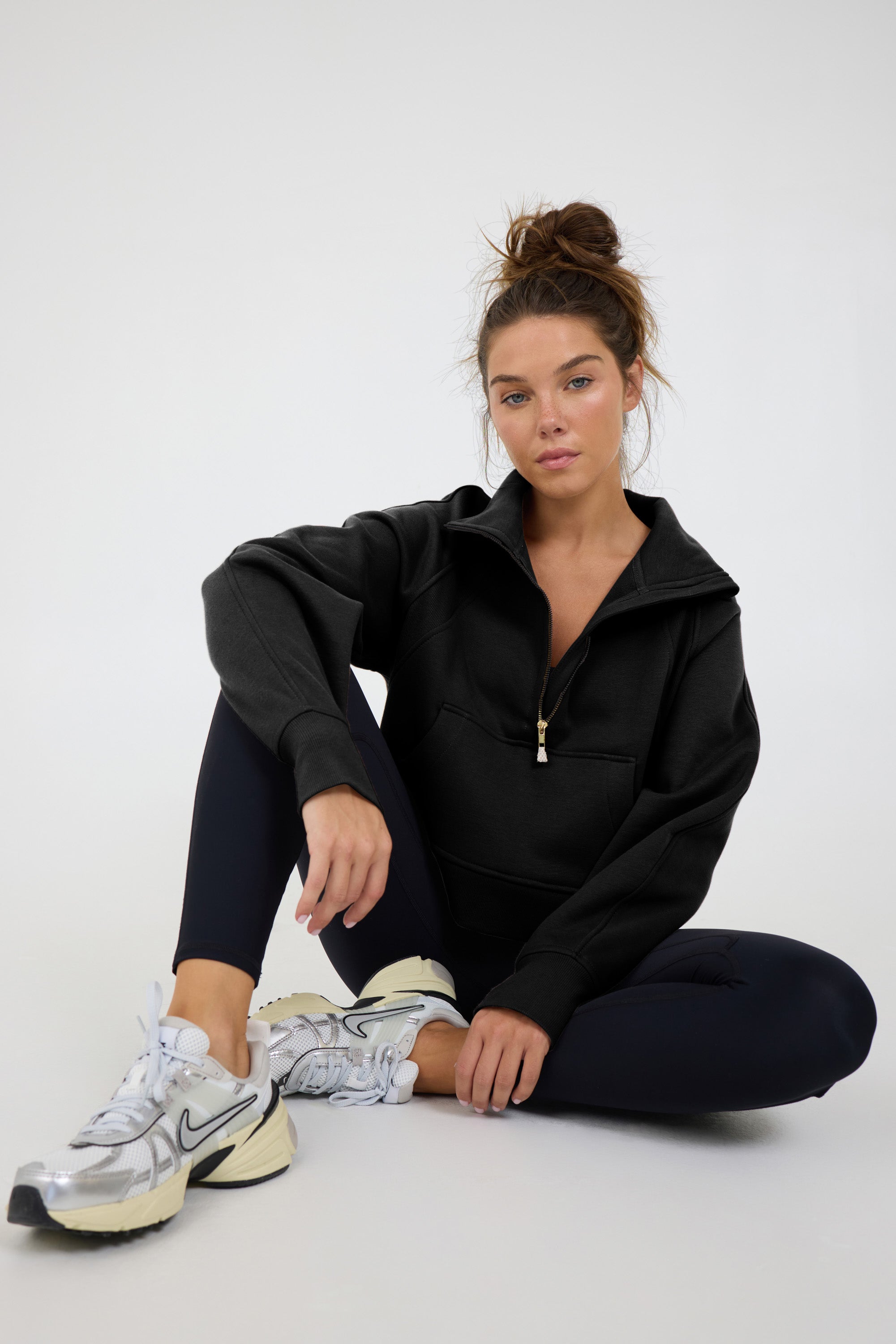 Morgan Fleece half zip long sleeve in black, modeled with the Lori Fleece joggers sitting down