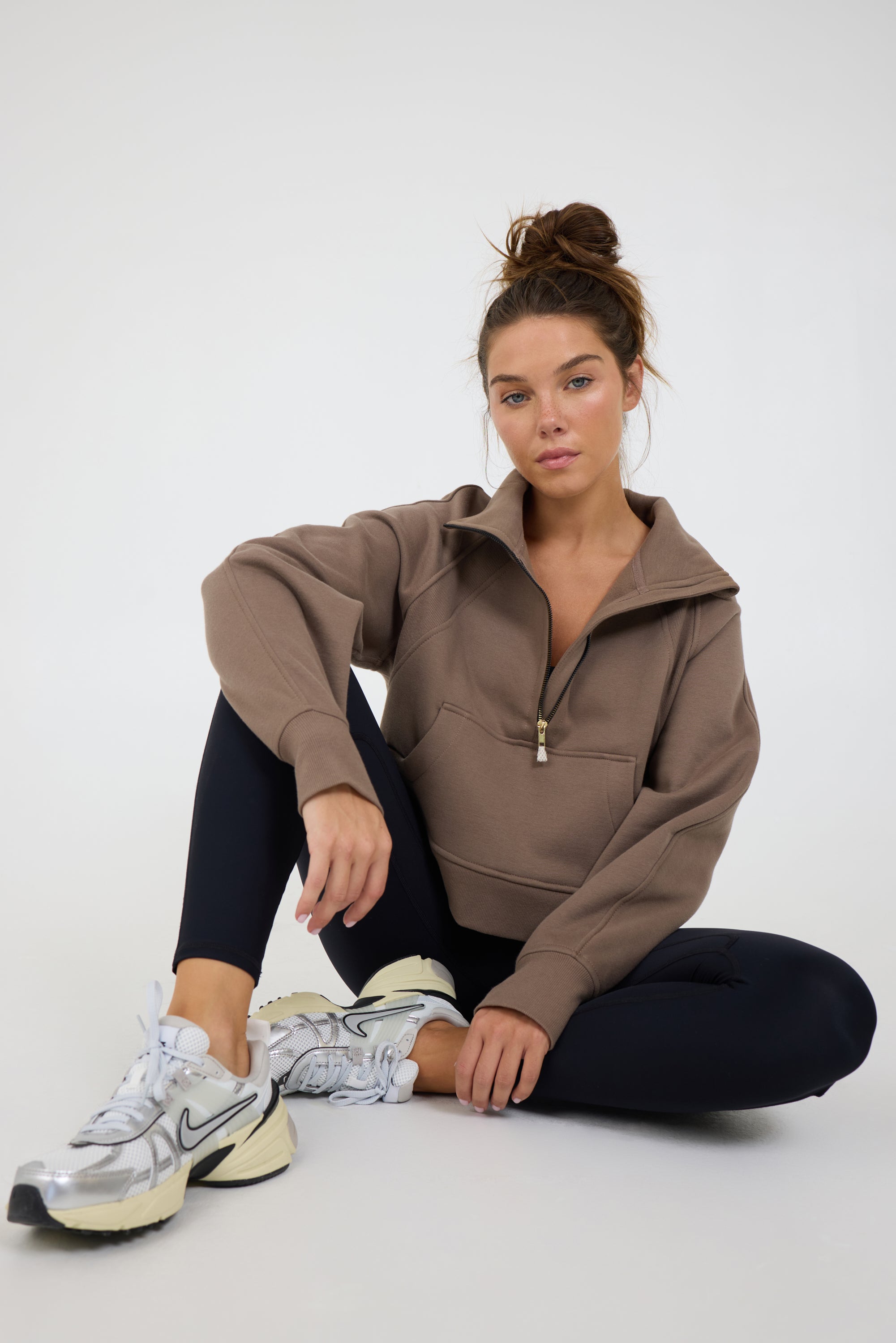 Morgan Fleece half zip long sleeve in dark truffle, modeled with the Lori Fleece joggers sitting down