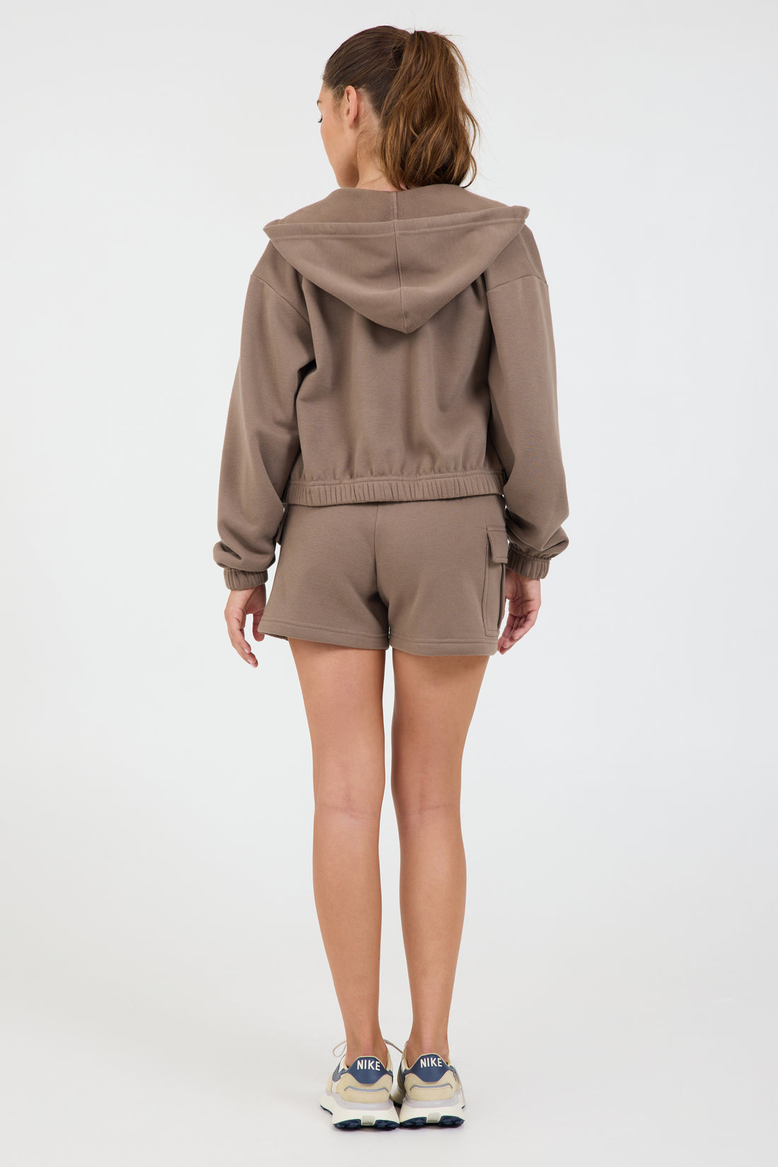 Nicole Fleece zipped cropped hoodie in dark truffle, modeled with the elasticized waist tank and the Sam fleece cargo shorts from the back