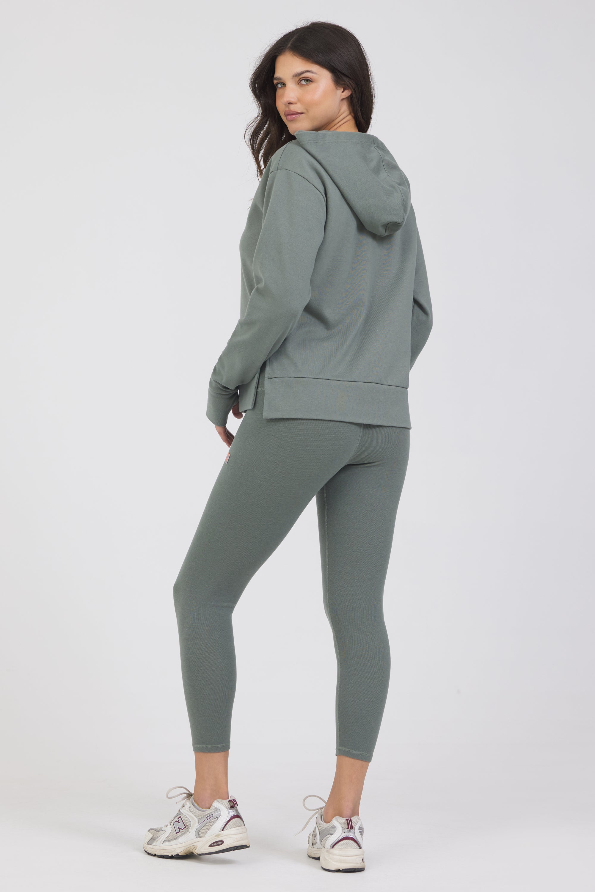 Long sleeve rib hoodie with side slits and thumbholes in teal from the back