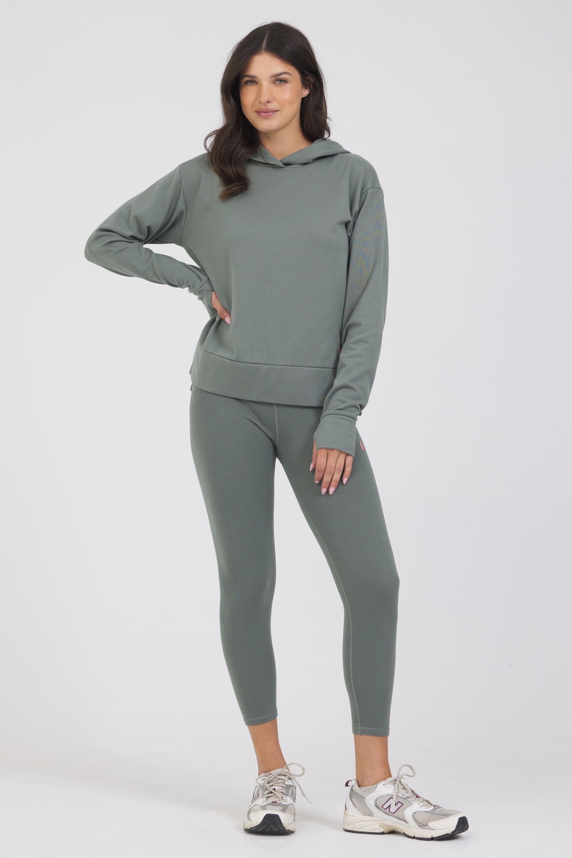 Long sleeve rib hoodie with side slits and thumbholes in teal from the front