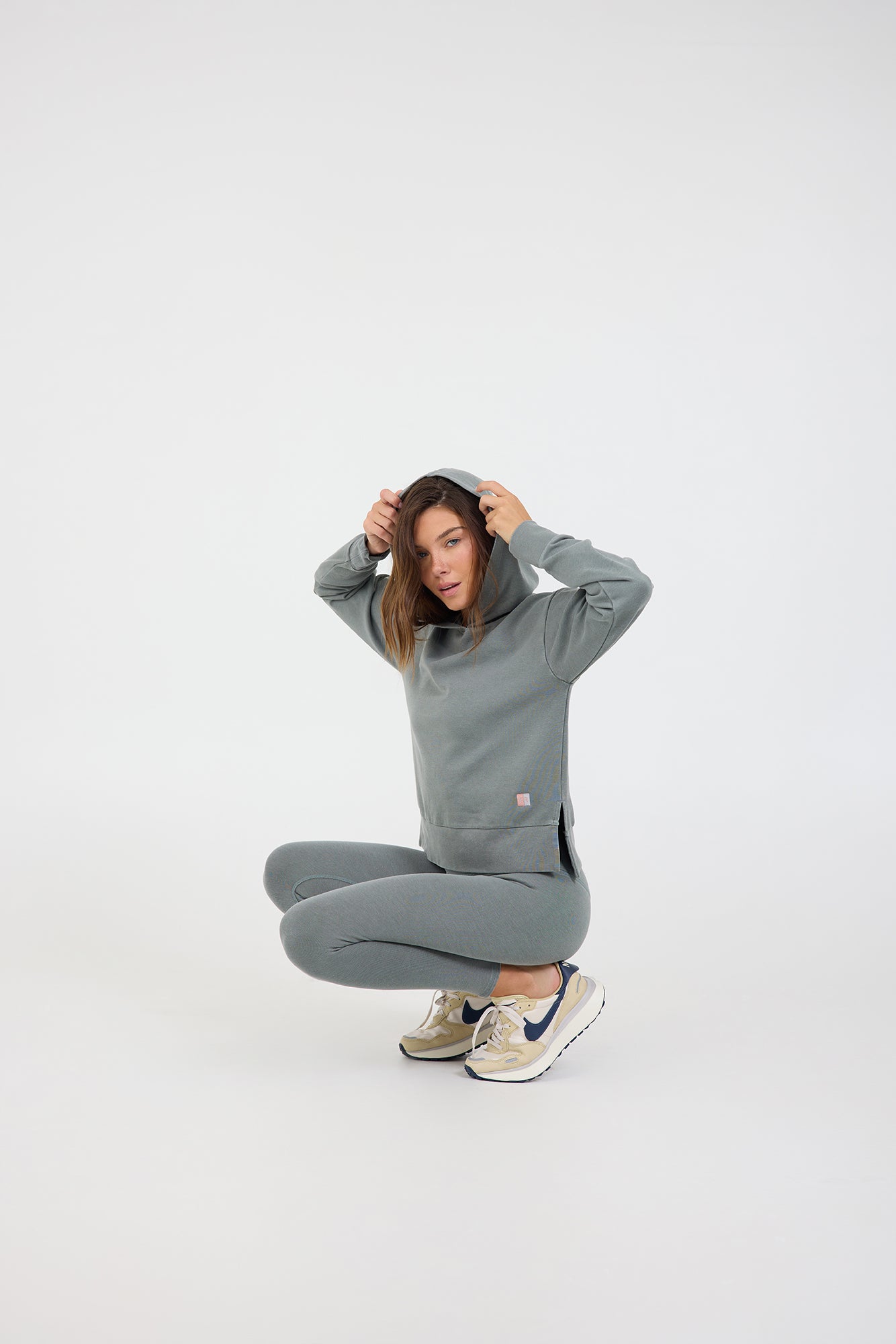Long sleeve rib hoodie with side slits and thumbholes in teal from the side