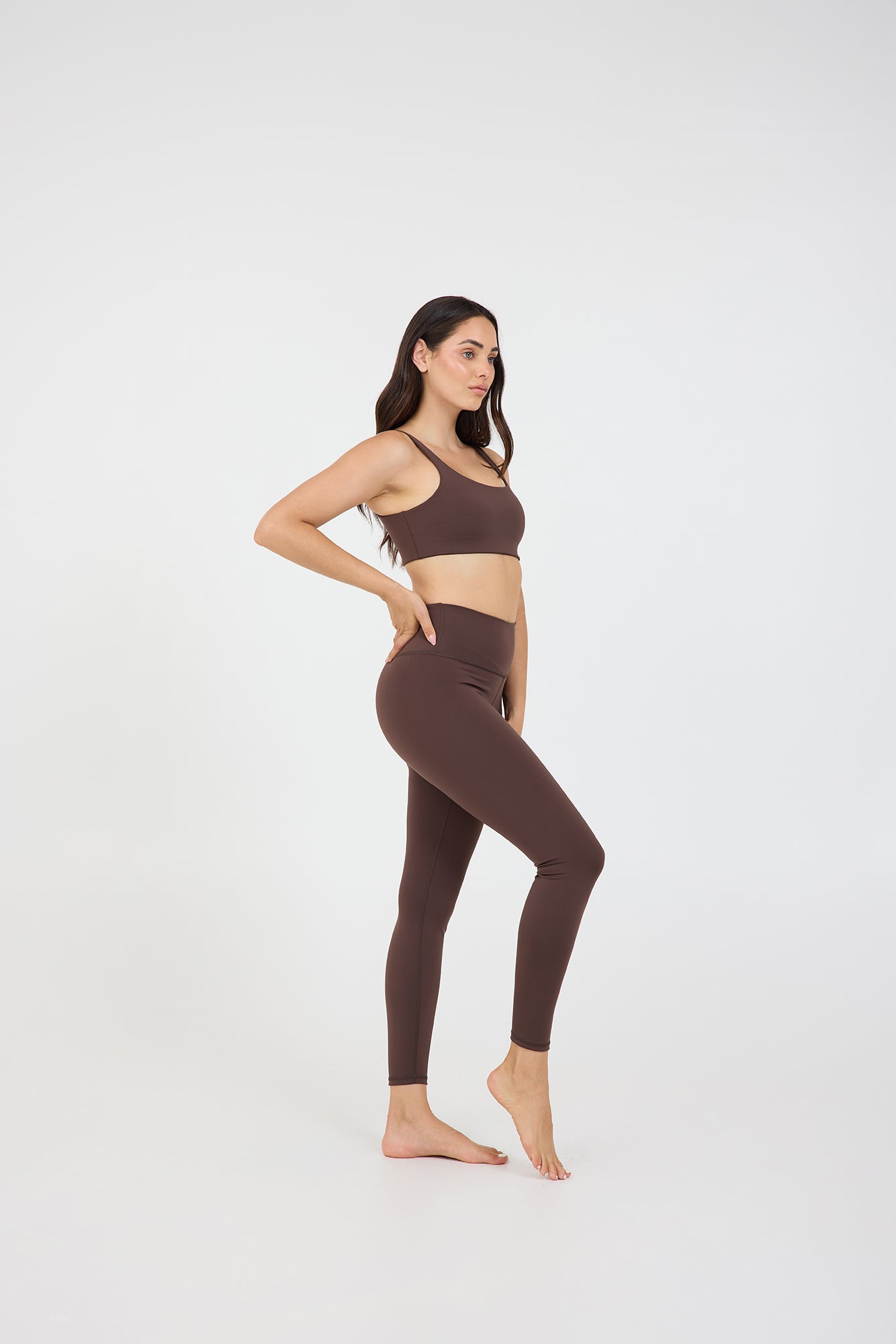 Taylor 7/8 leggings in dark fudge, modeled with the Taylor bra from the side